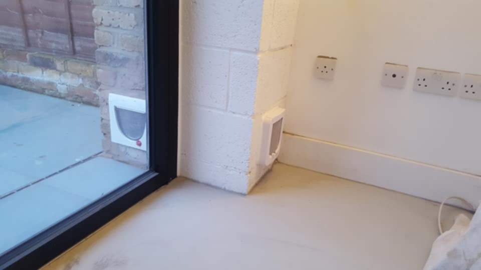 Cat flap fitted in a breeze block wall