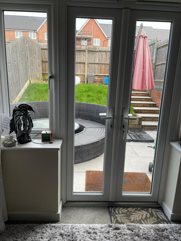 White uPVC French doors with clear DGU, with view of garden